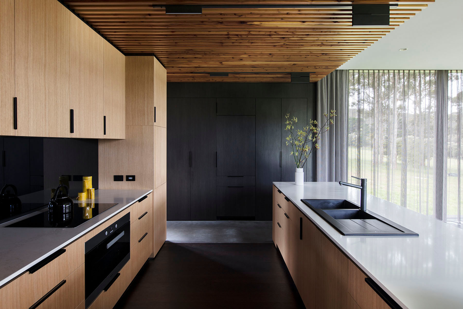 kitchen showing light timber cabinetry and timber battoned ceiling