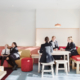 group of girls in school uniform talking at a table and couch area