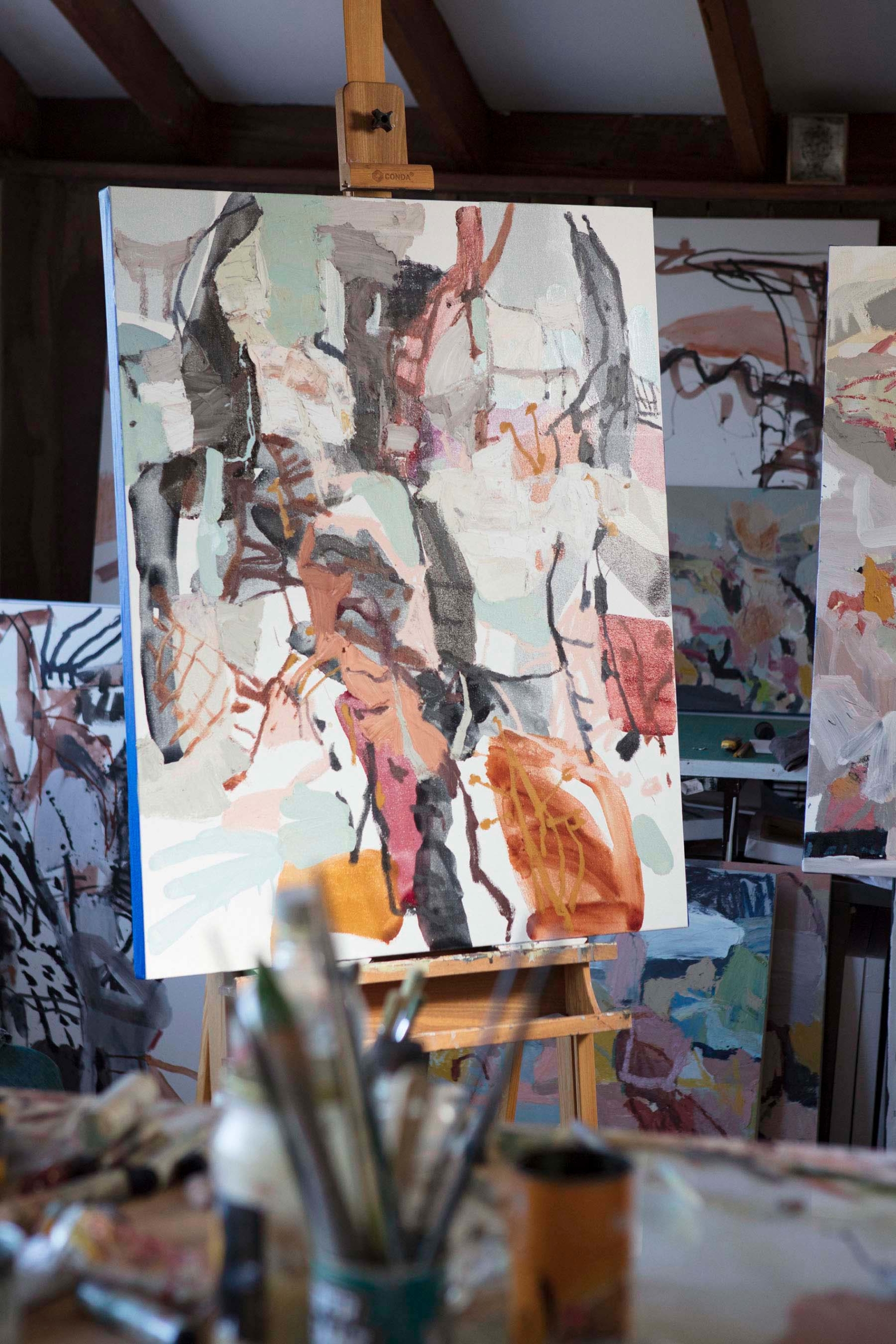 abstract artwork on an easel inside an artists studio