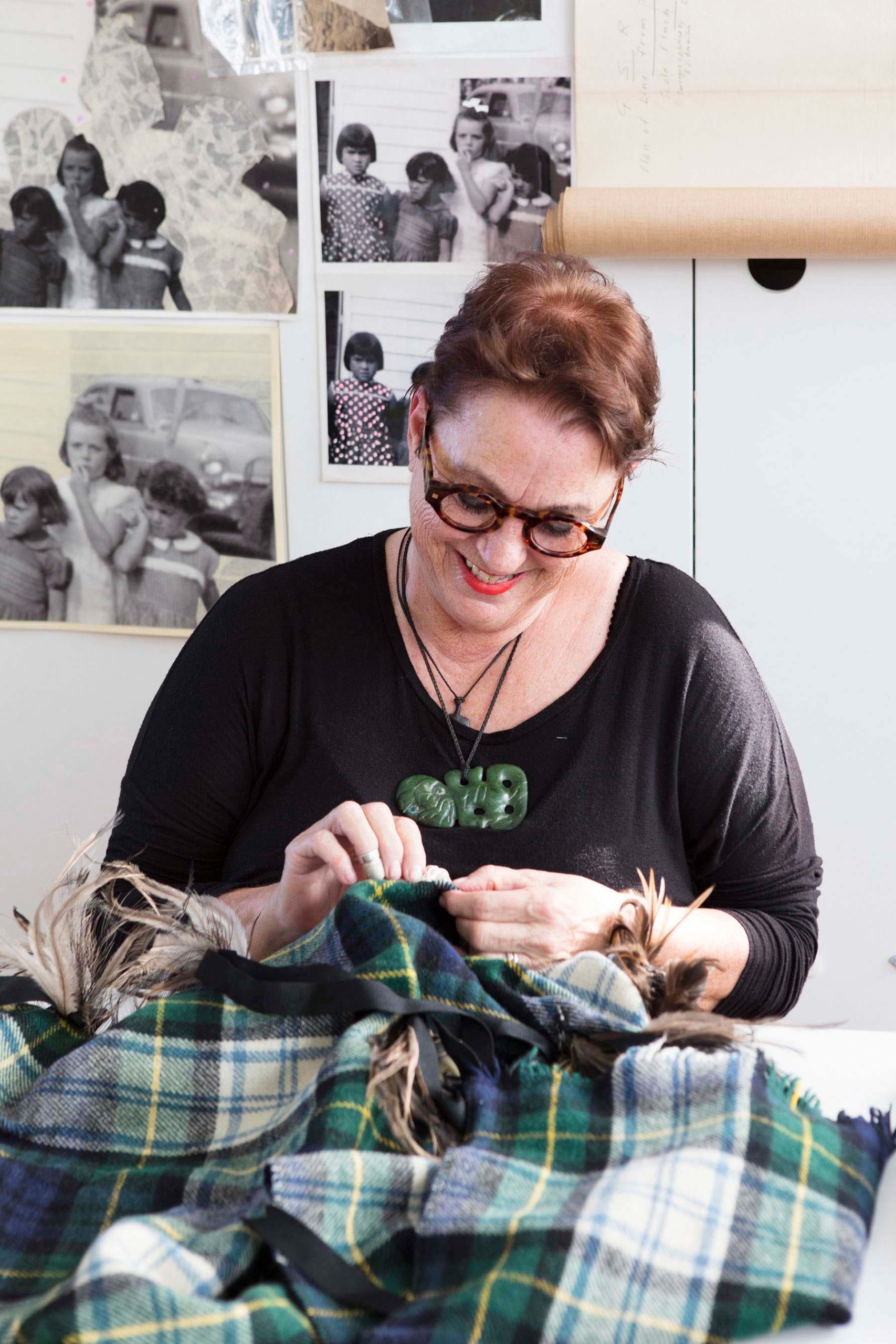 woman stitching and sewing artwork in their studio