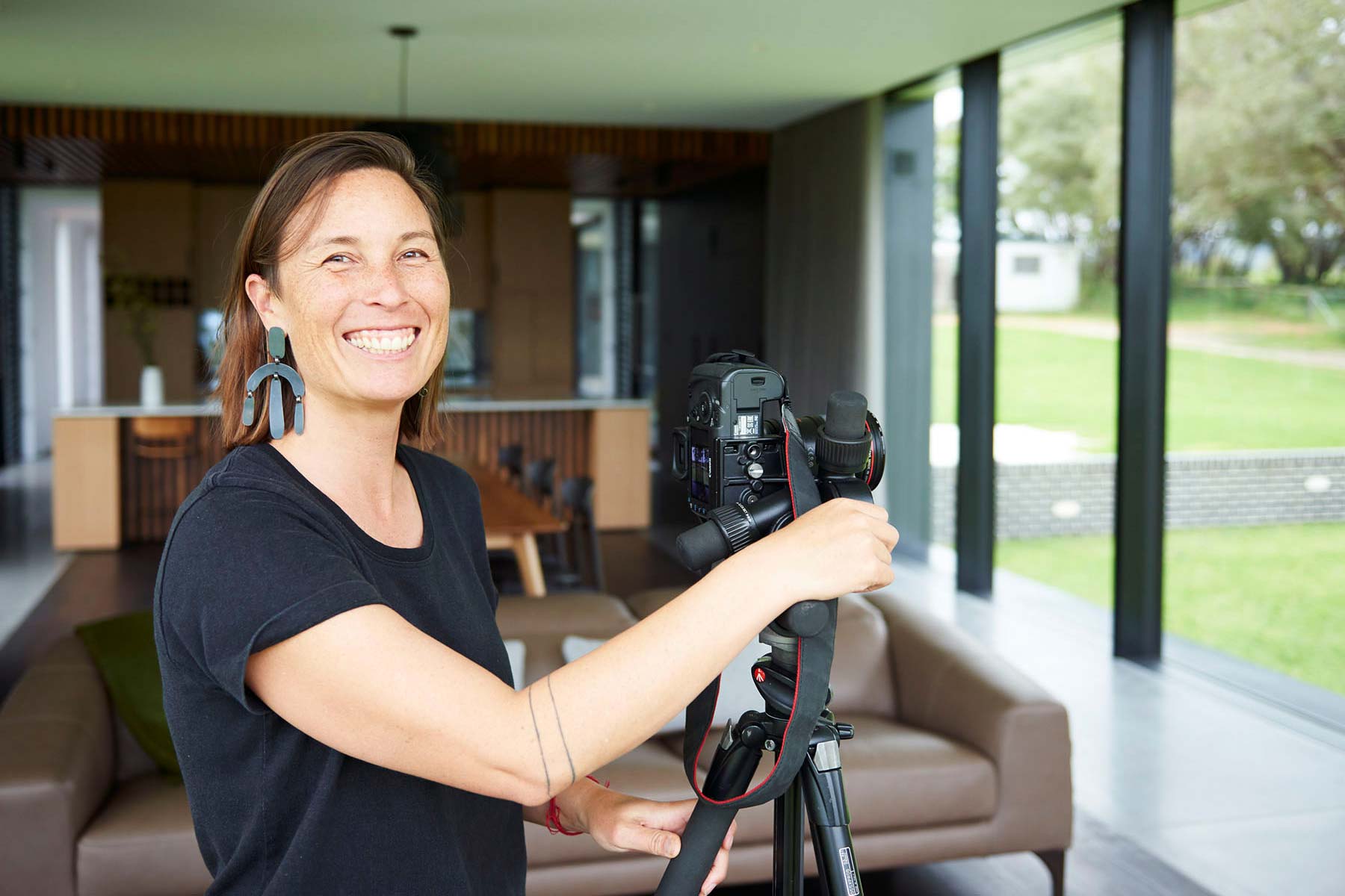 Bo with her professional camera set up in a modern architectural home